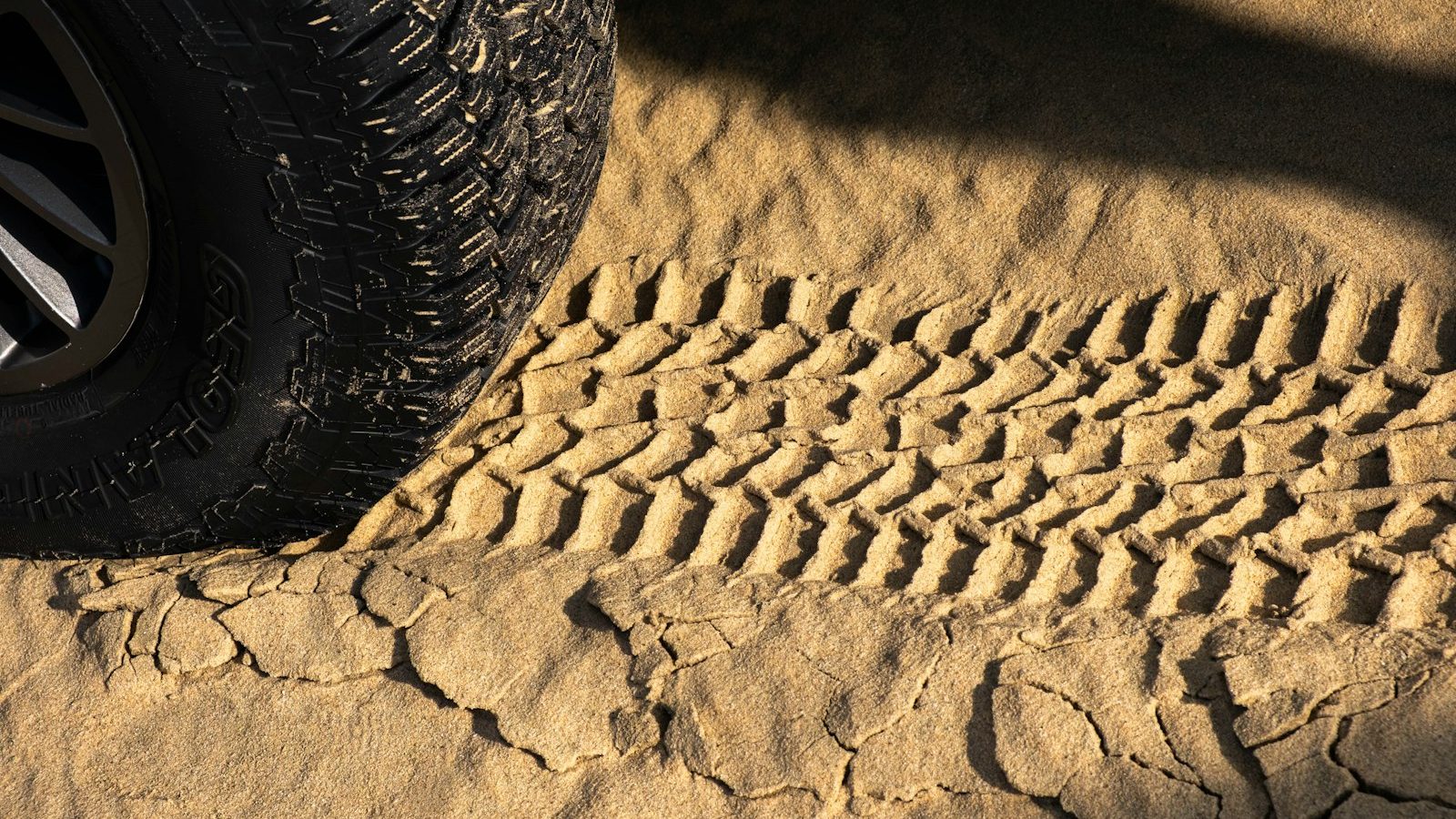 Off-road tire and tracks pressed into soft sand
