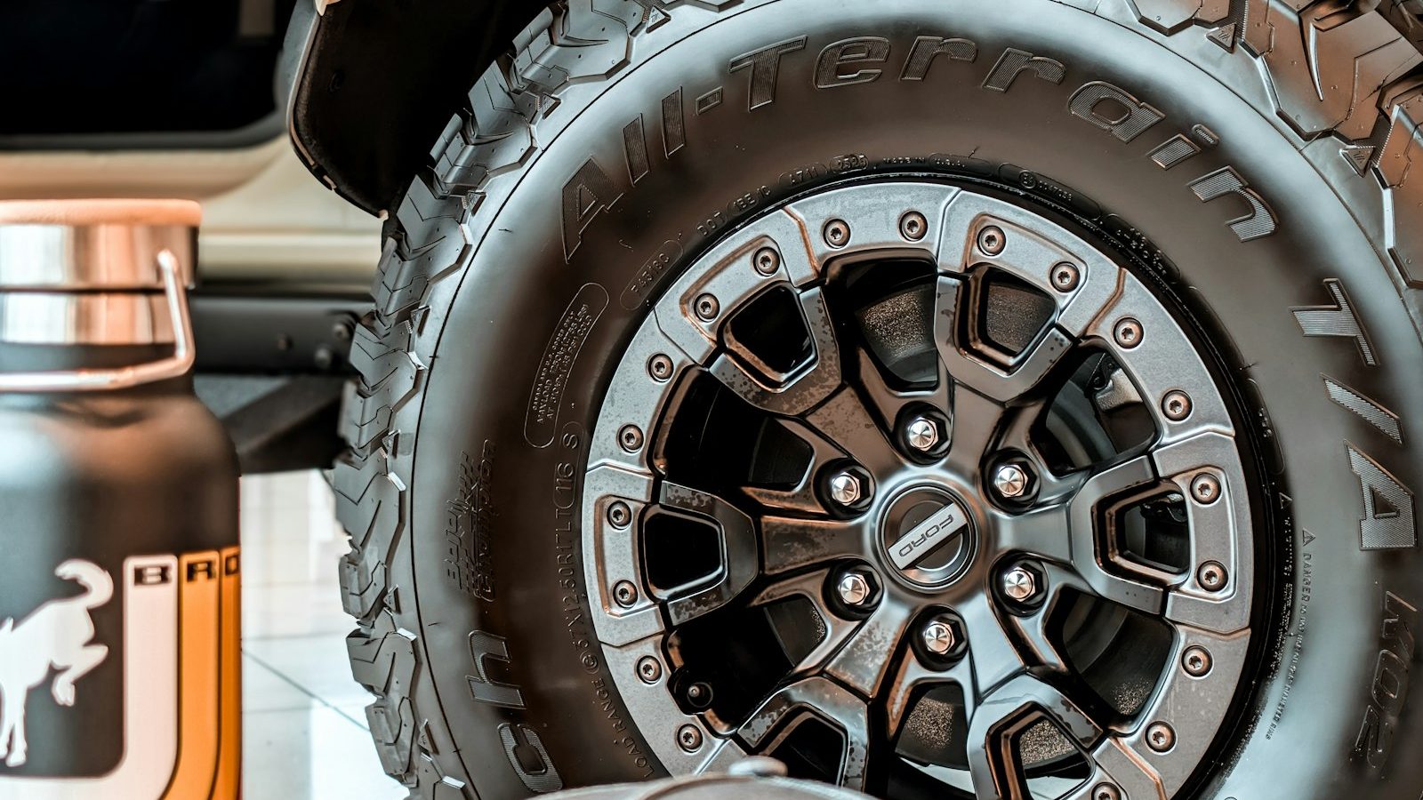 Close-up of an all-terrain tire sidewall on a black off-road wheel