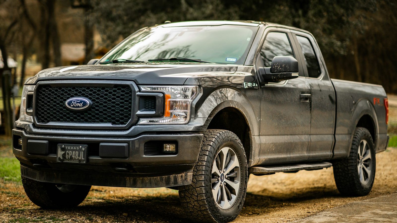 Dusty Ford F-150 parked on a dirt lot
